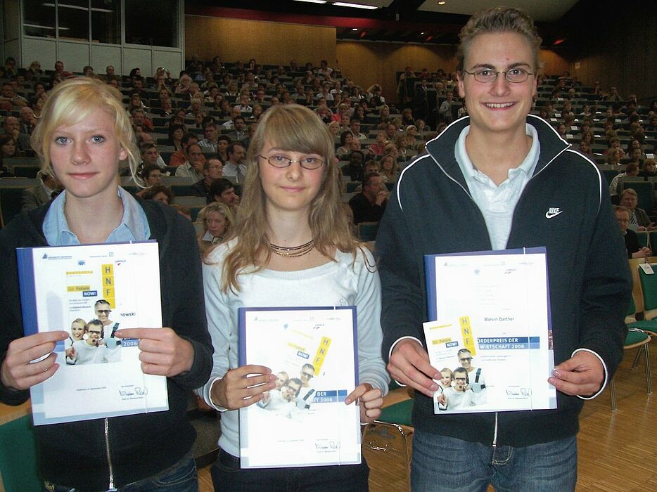 Foto (Mark Heinemann): (v.li.) Carolin Buranowski, Meike Rensberg und Marvin Barther mit dem Förderpreis der Wirtschaft sowie einer Eintrittskarte für das Heinz Nixdorf MuseumsFordum.