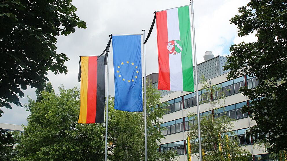 Foto (Universität Paderborn, Vanessa Dreibrodt): Trauerbeflaggung vor dem Audimax der Universität Paderborn.