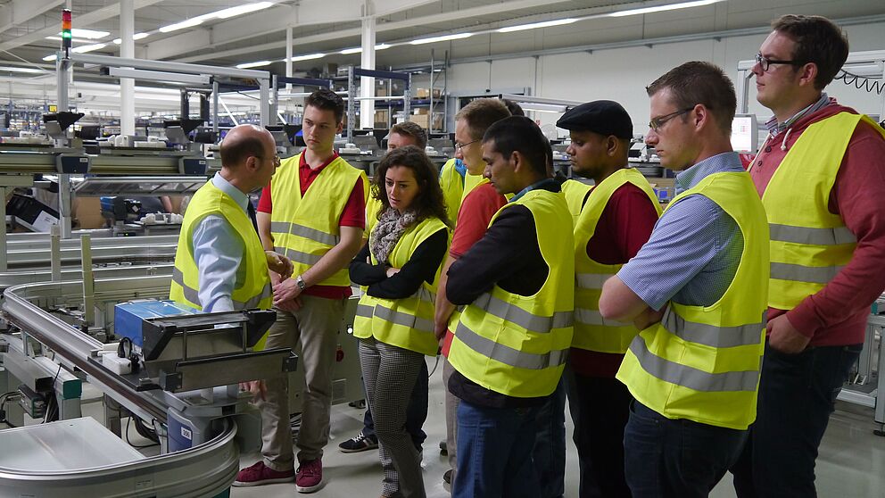 Abbildung: Bei der Hörmann KG erklärte Seminarleiter Horst Seibert den Studenten den Herstellungsprozess von Garagentorantrieben. Foto: pro Wirtschaft GT