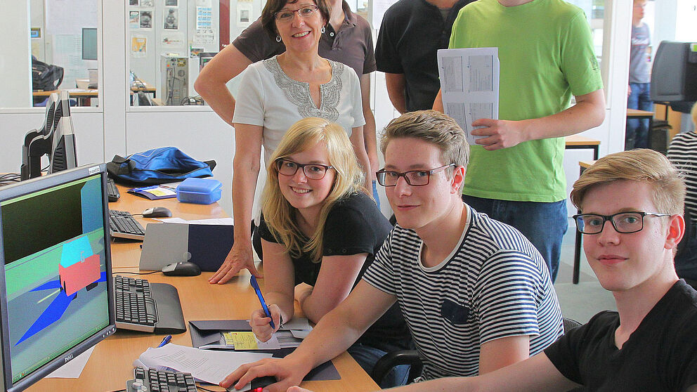 Foto (Thomas Thissen): Schüler aus dem Gymnasium Delbrück (am Tisch, v. l.) Teresa Göstenmeier, Marvin Düsterhus und Cedric Richter gemeinsam mit (hintere Reihe, v. l.) Prof. Dr. Gitta Domik-Kienegger, Dipl.-Inf. Stephan Arens, Dr. Hauke Friedrich und