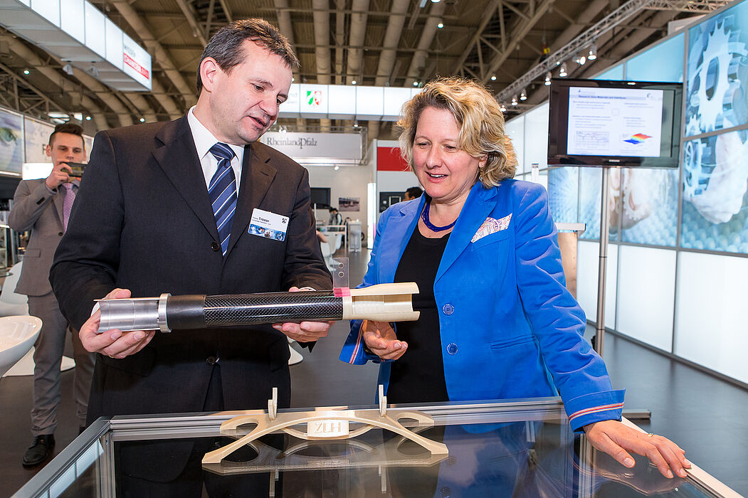 Foto (MIWF NRW): NRW-Wissenschaftsministerin Svenja Schulze im Gespräch mit Prof. Dr. Thomas Tröster, der anhand eines Demonstrators hybride Werkstoffe und Produktionsverfahren erläutert.